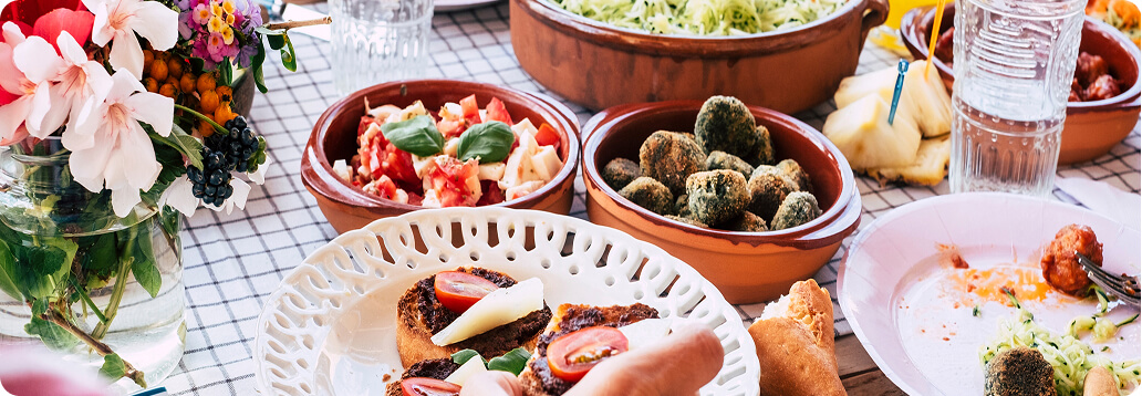 a table filled with healthy foods, flowers and water